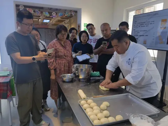 乐斯福烘焙讲师为“乡村烘焙师”学员示范面团整形
